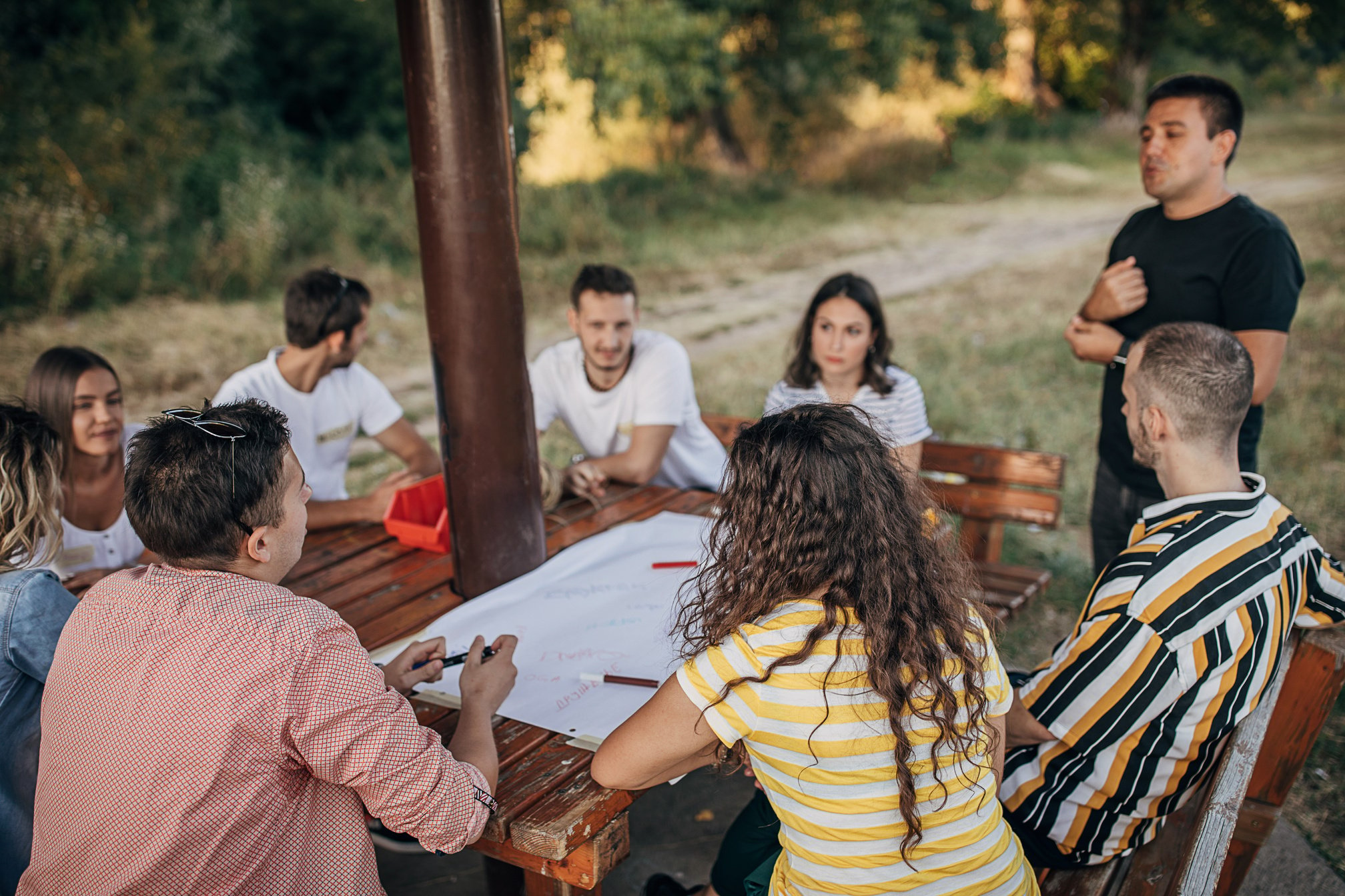 Group of youth people on a team building meeting at public park